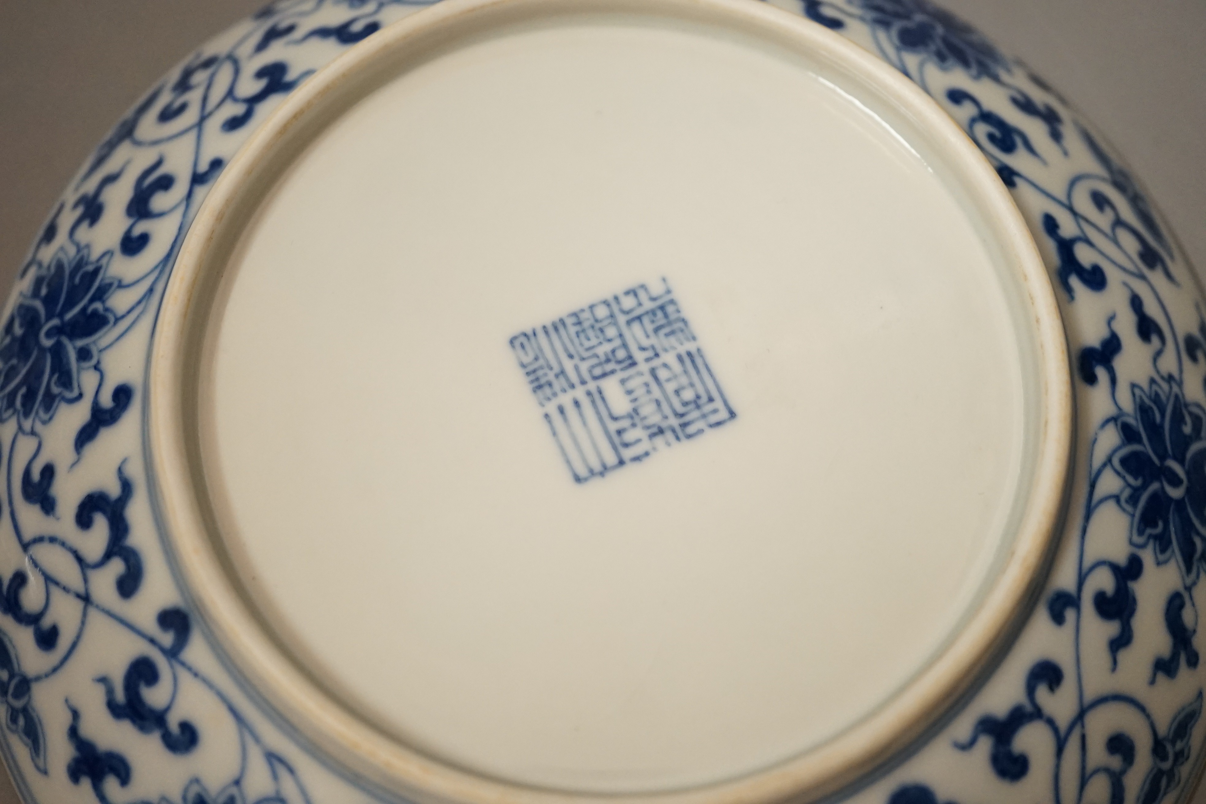 A pair of Chinese blue and 'white lotus' dishes, Qianlong marks, 16.5cms diameter